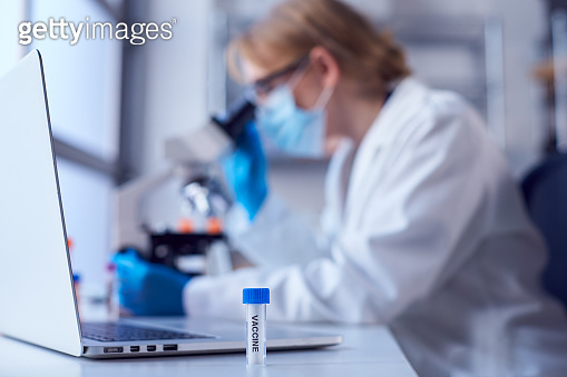 Female Lab Worker Wearing Lab Coat Working On Vaccine In Laboratory ...