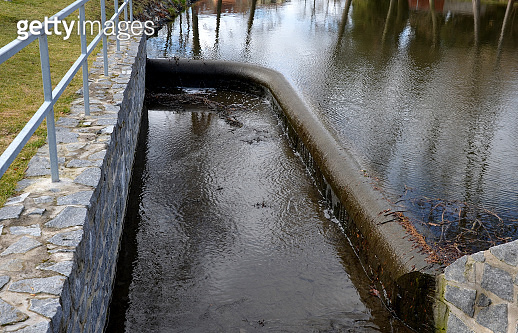 bridge over safety spillway of the dam. stone bridge with natural ...