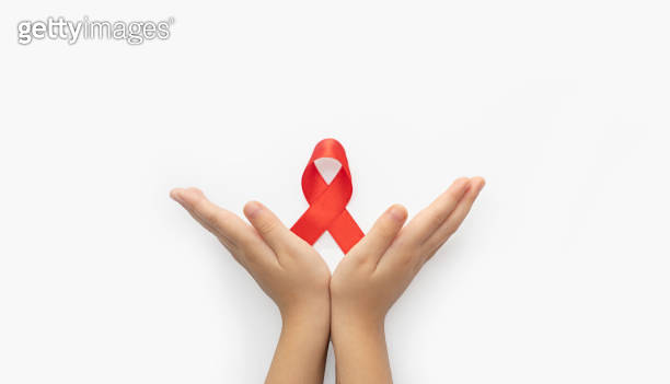 World Aids Day. Child palms with red ribbon over white background ...