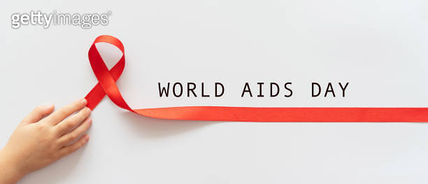 World Aids Day. Child palms with red ribbon over white background ...