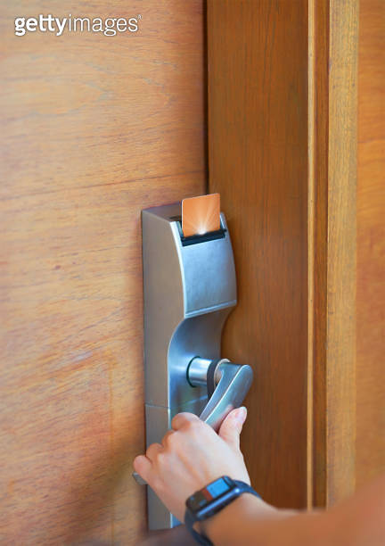 hand open doorknob after inserts card to open electronic lock in hotel ...