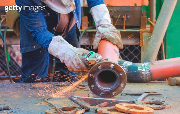 Pipe Line Hand Welder hand using grinder machine to polishing steel pipe for improving ...