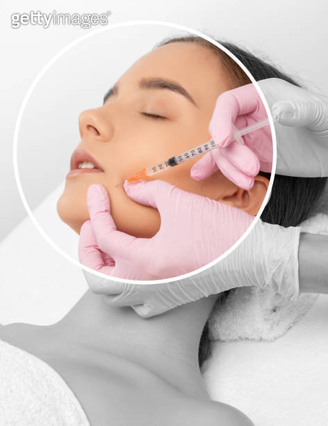 Cosmetologist makes rejuvenating anti wrinkle injections on the face of ...