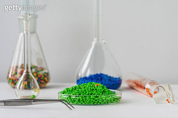 Plastic Lab Vert Plastic factory laboratory. Glass flasks with colored dye in granules ...
