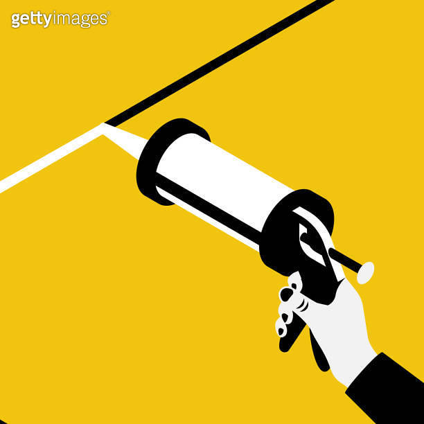 Sealant for sealing holes. The worker holds a caulk gun in hand. 이미지