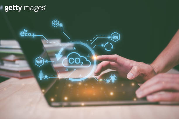 man using computer laptop working with sign CO2 reducing icon in ...