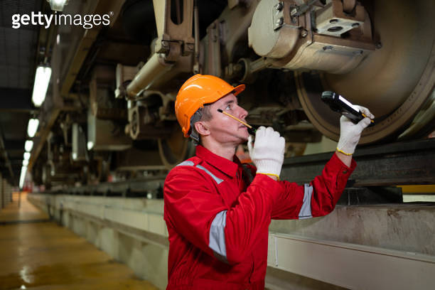 Electric train engineer use a walkie-talkie to inspect electric train ...