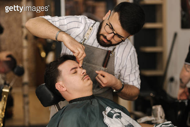Threading Machine Barber Process of threading procedure in barber shop. Professional barber ...