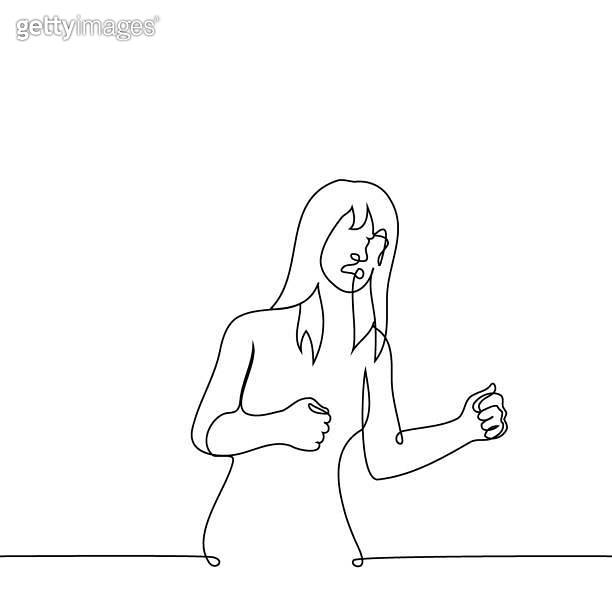 woman stands with clenched fists and a grimace of rage or irritation on