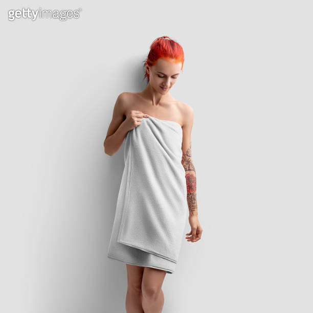 Mockup of a white bath towel on a redhaired girl with a tattoo