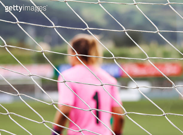 the-net-of-a-goal-through-which-the-goalkeeper-of-a-women-s-football