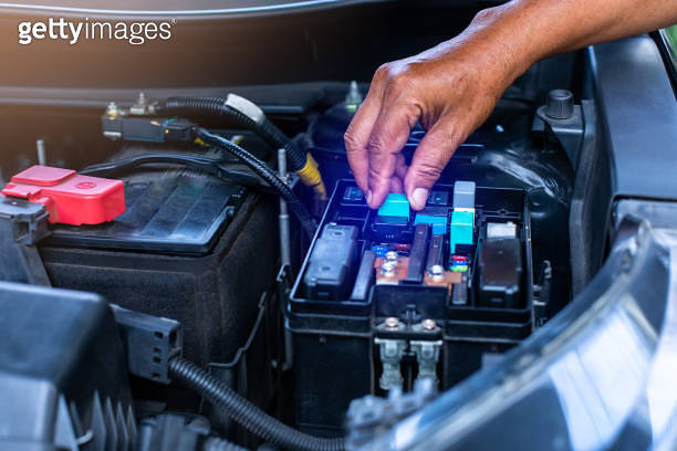 Control Box Vehicle Computer A mechanic is opening the cover of a car's electrical system control ...