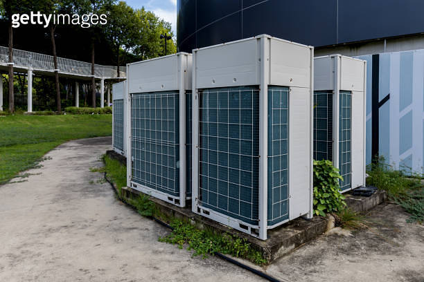 Air conditioner compressor installed in old building. Outdoor split ...
