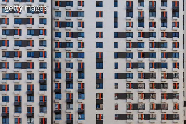 The wall of a new multi-storey building with the same type of windows ...