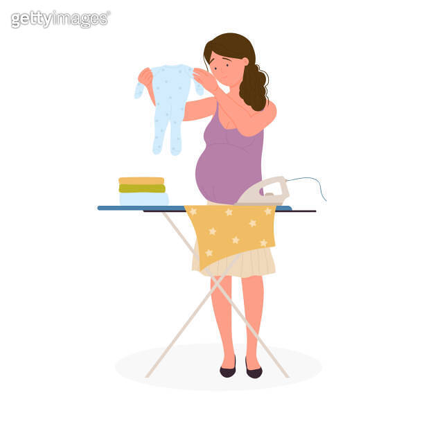 Pregnant woman ironing baby clothes, household chores before birth of