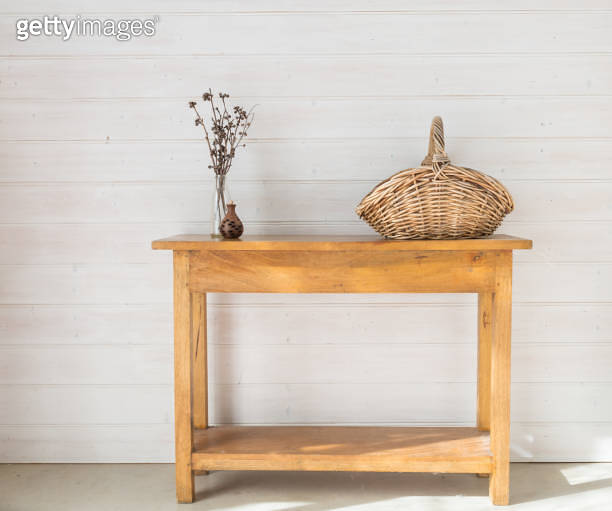 Oak side table with accessories including seedpod, dried twigs and