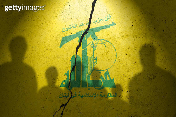Flag of terrorist organization Hezbollah painted on the concrete wall