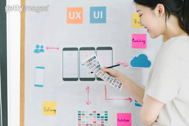 Creative UX UI designer working on screens for mobile responsive ...