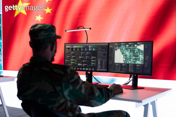 Military officer in uniform monitors critical data on big screen ...