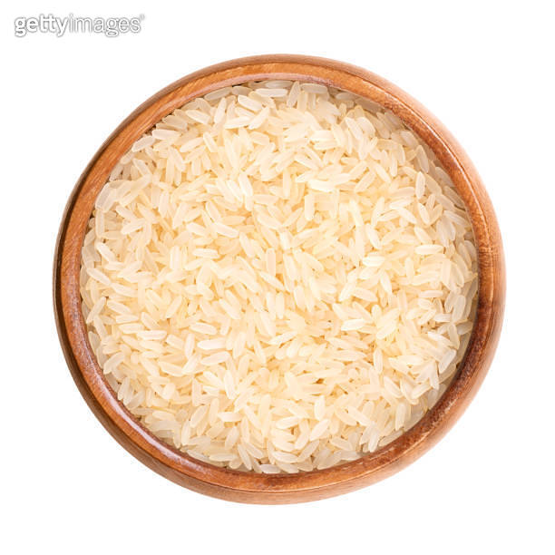Parboiled long grain rice, converted or easycook rice, in a wooden