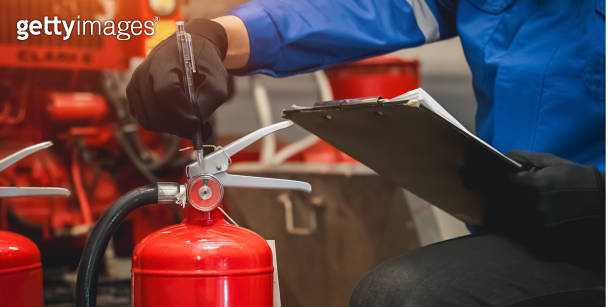 Engineer check fire extinguisher tank in the fire control room for ...