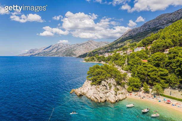 Aerial view of Punta Rata beach with boats and azure sea in Brela ...