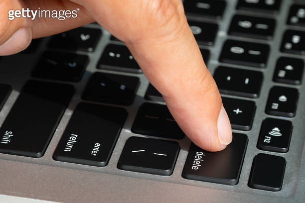 Computer Finger Key Finger of the computer user, he presses the delete button on the ...