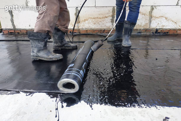 Worker covered surface, bitumen primer for improving adhesion during ...