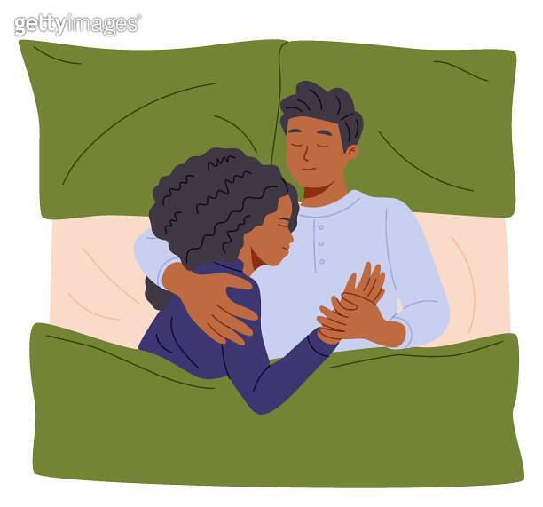 Young couple sleeping together cuddling under blanket in modern bedroom ...
