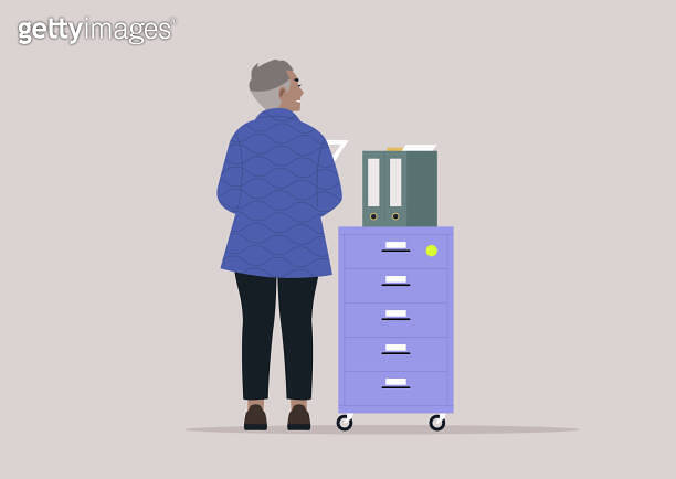 Employee Organizing Files in a Modern Office Setting, A person stands ...