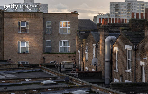Rear view of urban brick apartment buildings and old houses in london ...
