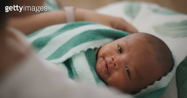 Young asian mother holding newborn in arms Rocking for baby to sleep ...
