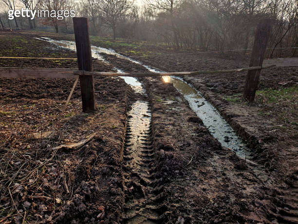 muddy paths through fields and paddocks. ruts after heavy equipment ...