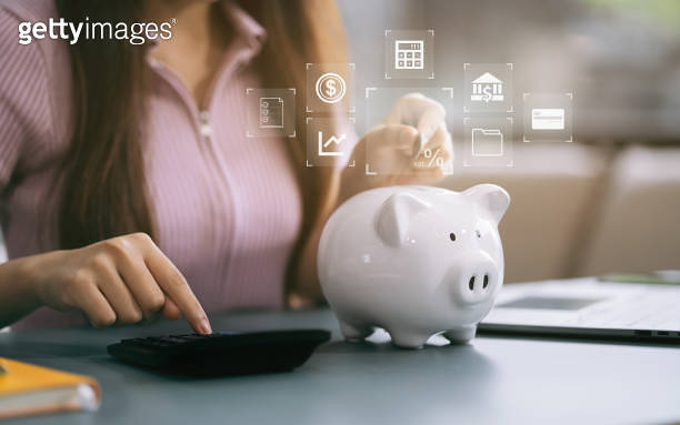 Using Money concept with saving money, Female working on desk in home using ...