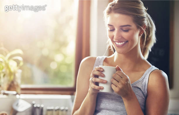 Home, smile and woman with coffee in morning for caffeine, beverage and ...
